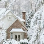 outside picture of a home surrounded by lots of snow.