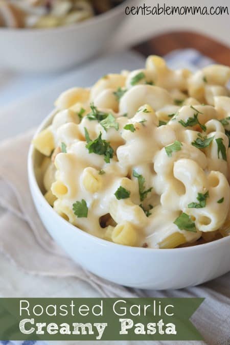 This Roasted Garlic Creamy Sauce recipe with macaroni pasta is perfect comfort food with a delicious combination of homemade cream sauce with roasted garlic over macaroni. Yum!