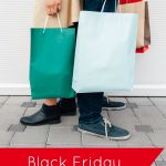 man and woman standing back to back holding shopping bags