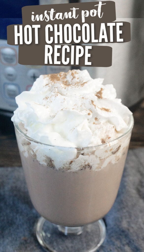 hot chocolate with whipped cream and nutmeg on top in a glass sitting in front of an Instant Pot (with text overlay).